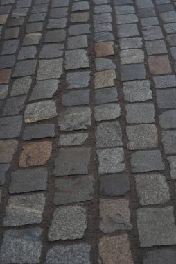 Gri kaldırım taşlarıyla döşenmiş eski Avrupa avlusu. Pavers dokusu. Sokak Yolu 'nun zeminindeki monoton gri tuğla kaldırıma bir bakış açısı. Kaldırımlar, garaj yolu, kaldırımlar
