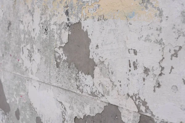 Cracked wall.White peeling wall.Closeup of peeling painted wall.old white paint wall with crack texture.White Grunge Peeling Painted Concrete Wall Texture Background. White and Gray Dirty Plaster Wall