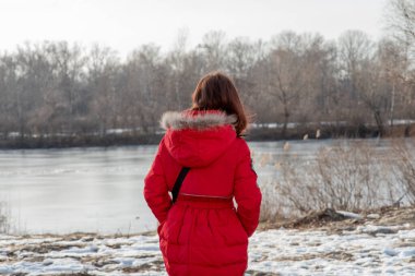 Dokuz yaşında güzel bir kızın portresi. Kış kıyafetleri içinde okul çocuğu. Kız 9 yaşında. Genç, portre. Kırmızı ceketli kız. Yeni nesil. Z neslinin çocukları.