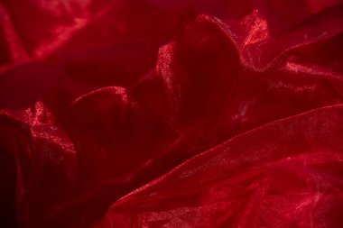 Organza kırmızısı. Soyut arkaplan kırmızı şifon organza. doku arkaplan deseni kırmızı ipek kumaş. Bu ipek organzanın açık bir dokuması var..