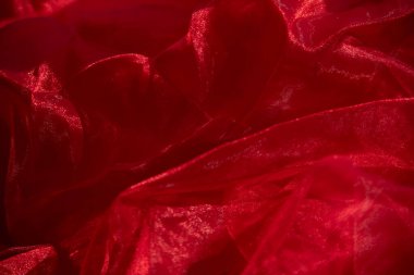 Organza kırmızısı. Soyut arkaplan kırmızı şifon organza. doku arkaplan deseni kırmızı ipek kumaş. Bu ipek organzanın açık bir dokuması var..