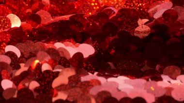 kırmızı pullar tekstil arka planı. Kumaşın dokusu. Kumaşta kırmızı parıltılar var. Kırmızı.