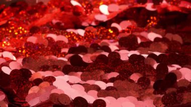 kırmızı pullar tekstil arka planı. Kumaşın dokusu. Kumaşta kırmızı parıltılar var. Kırmızı.