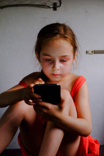 Cute girl in the train. Summer Vacation and Travel Concept. A girl of 5 or 6 years old rides on a train. Teen travels. Little girl with long hair. Child portrait