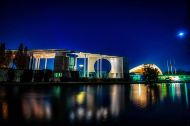 the illuminated chancellors office seen from the river Spree 