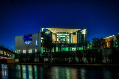 the illuminated chancellors office seen from the river Spree 