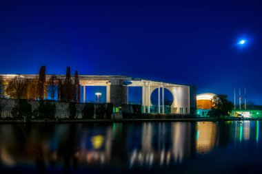 the illuminated chancellors office seen from the river Spree 