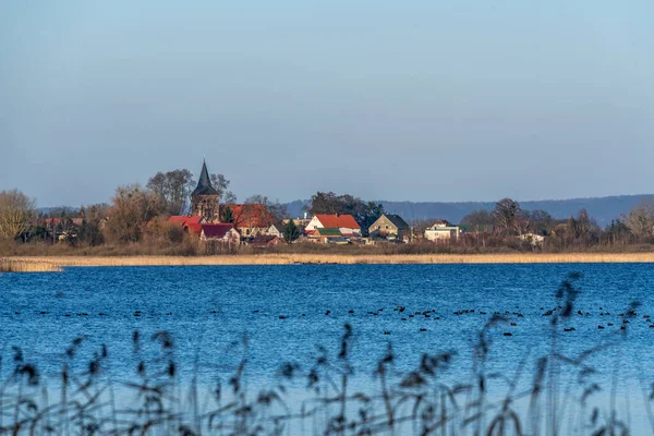 The village Weltyn in Poland seen across the lake