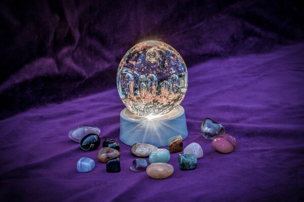 Close up of an Illuminated paperweight surrounded by semi precious stones