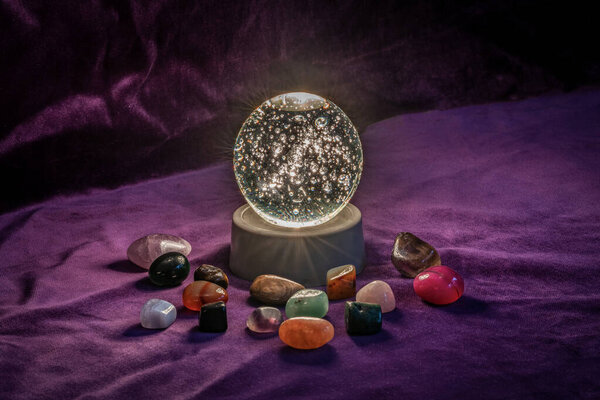 Close up of an Illuminated paperweight surrounded by semi precious stones