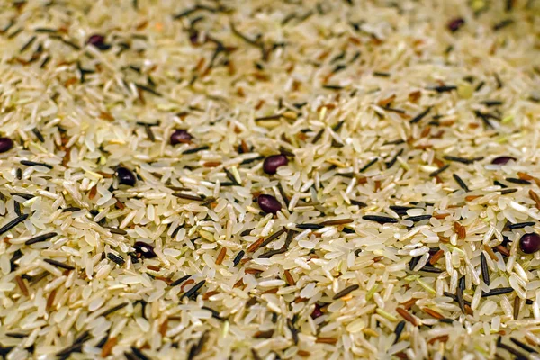 Food background with four mixed varieties of Thai rice: brown rice, mixed wild rice, white basmati rice, ruby red rice and bean beans and lentils. keto diet.