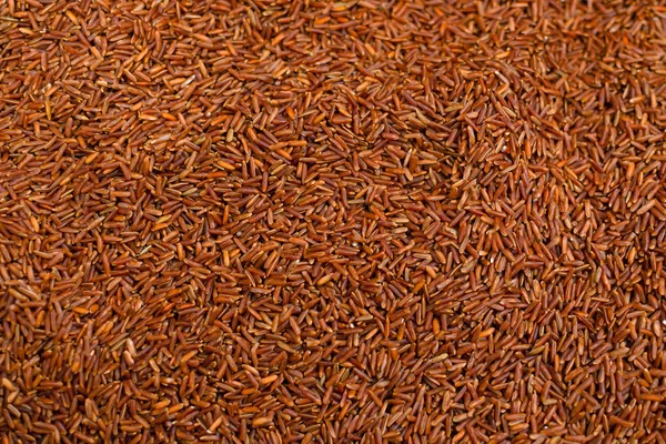 Rice background, red rice close-up, top view, food diets.