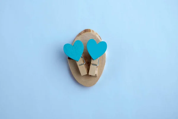 Small clothespins with blue hearts on a white background — Stock Photo, Image