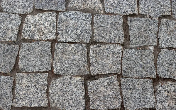 石头路面纹理 花岗岩鹅卵石路面背景 圆石路常规形状 抽象背景的旧鹅卵石路面特写 — 图库照片
