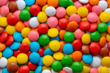 Background of small multicolored dragees. sweet color candy clipart
