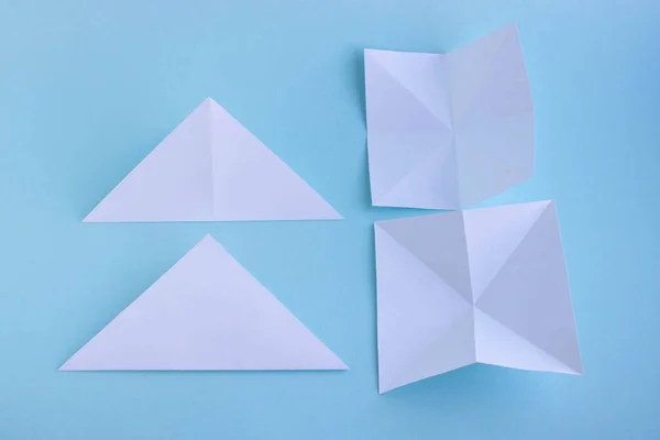 Step 1. Handmade white trendy geometric polygonal paper origami fish on blue background. — Stock Photo, Image