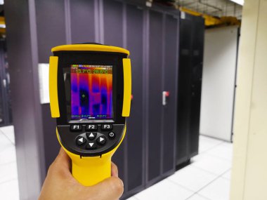 engineer use Thermal scan Scan to Server computer for temperature checking in Server room clipart