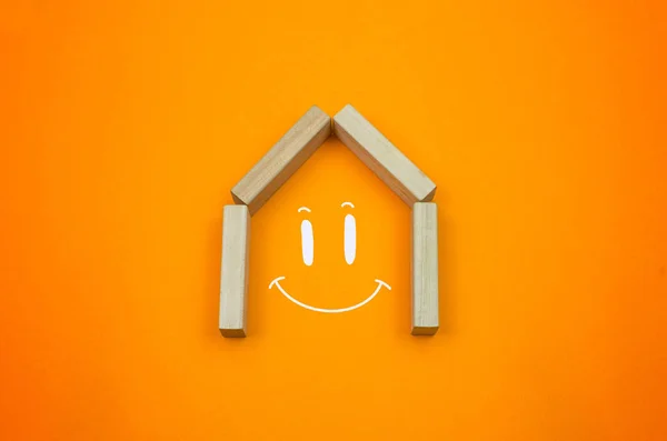 Building house or home with smile, happy house drawing copy space on the gradient warm background
