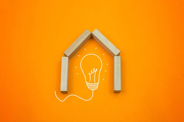 Creative house, home from toy blocks on the gradient, orange background idea creative concept bulb with home