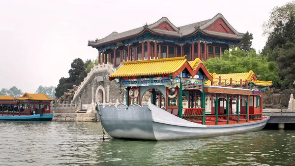 Imperial Summer Palace. Traditional Chinese-style boats ride tourists on Kunming Lake.