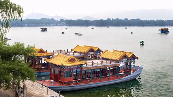 Imperial Summer Palace. Traditional Chinese-style boats ride tourists on Kunming Lake.