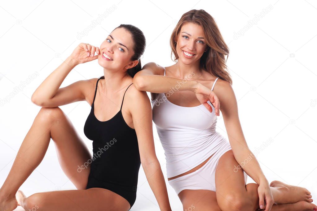 Two beautiful young woman with perfect skin enjoying the moment.