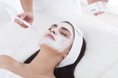Yüzünde bir maske ile spa kadındır.
