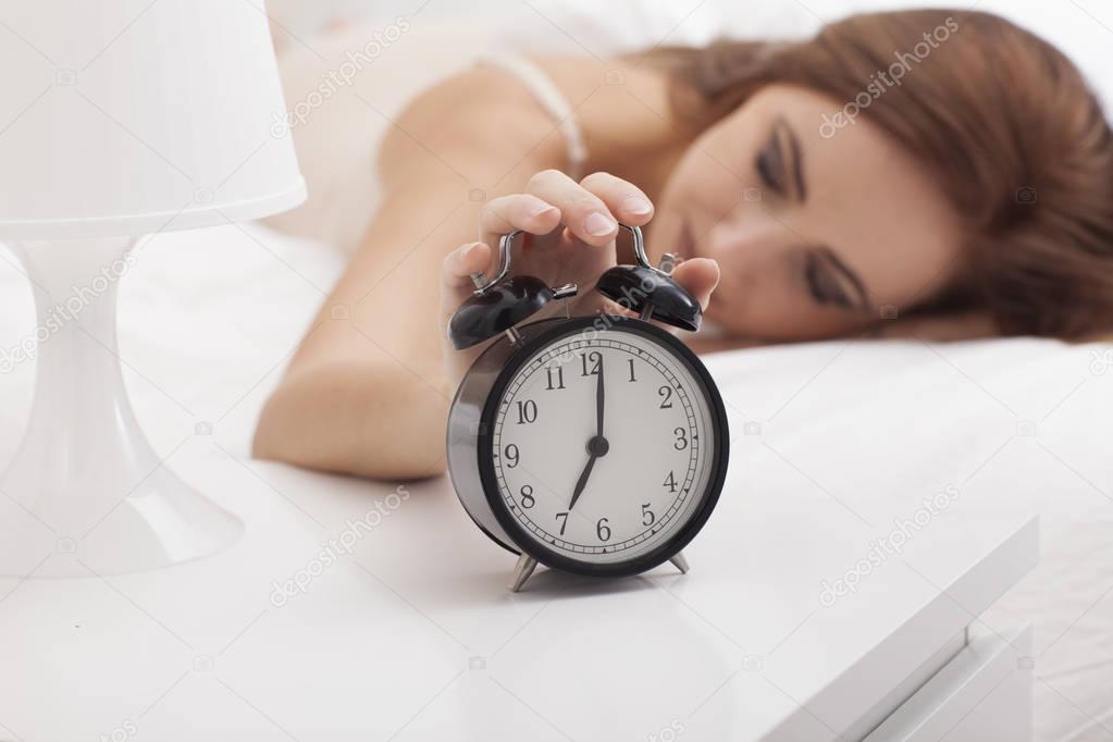 Young woman is not ready to wake up.