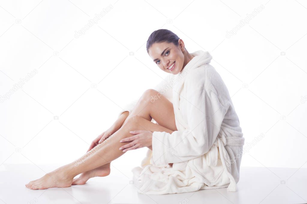 Beautiful woman enjoying free day in bath robe.