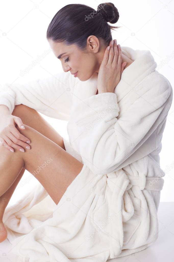 Beautiful woman enjoying free day in bath robe.