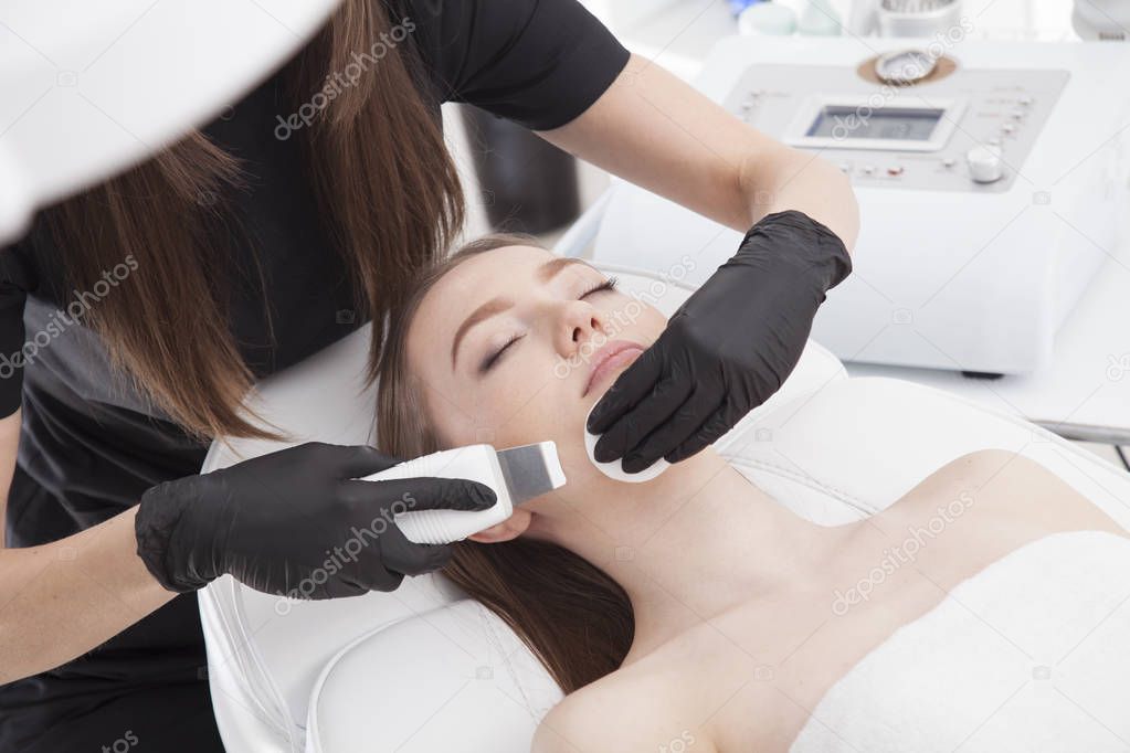 Beautiful woman is having a facial treatment in spa. Cavitation peeling.