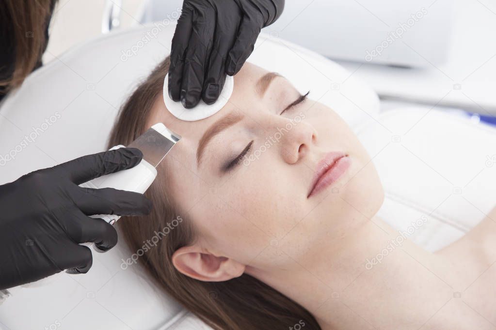 Beautiful woman is having a facial treatment in spa. Cavitation peeling.