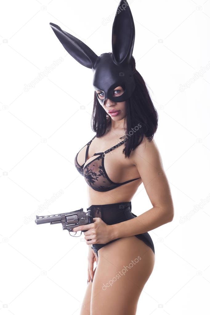 Sexy woman in black bikini in rabbit mask isolated on white background.