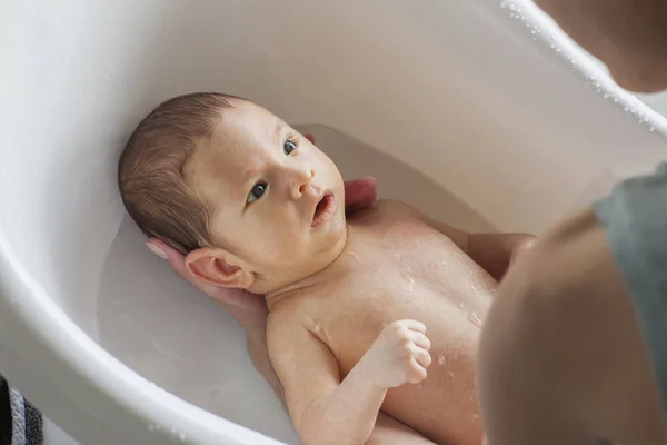 Pequeno Bebê Está Tomando Banho Nos Braços Sua Mãe — Fotografia de Stock