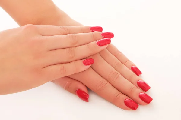 Perfectly done red manicure on studio shoot.