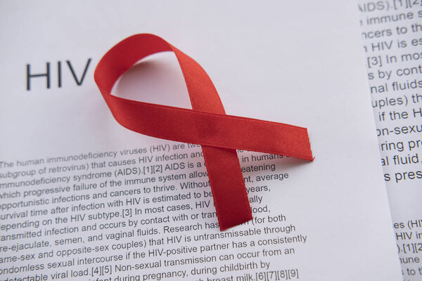 Red ribbon as a sign of HIV in laboratory scenery. Medical life.