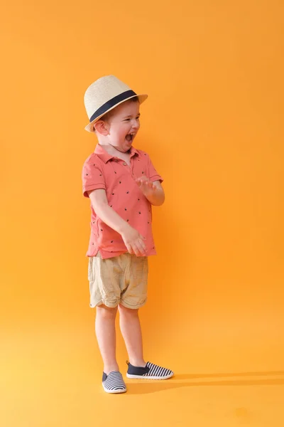 Super happy and stylish baby boy is ready of holiday. Summer outfit.