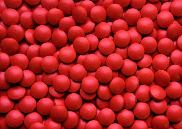 Mnóstwo Czerwonych Okrągłych Mrożonych Tabletek — Zdjęcie stockowe