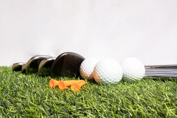 Golf equipment placed on a green artificial grass represents preparation for a golf game — 스톡 사진