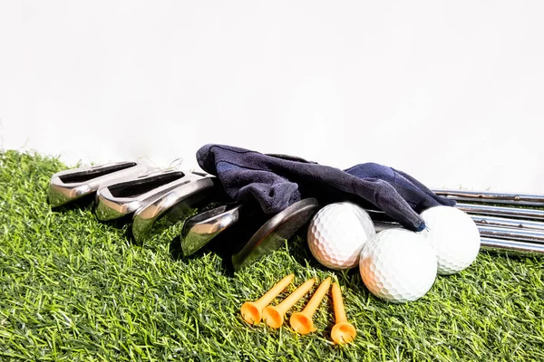 Golf equipment placed on a green artificial grass represents preparation for a golf game — 스톡 사진