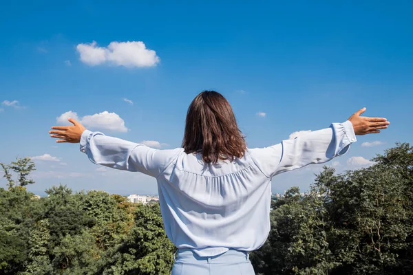 Business woman enjoying freedom feeling happy at blue sky background