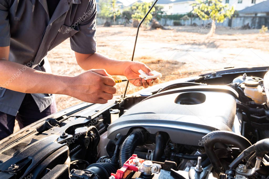 The hands of the repairman are checking the order of the engine using modern tools