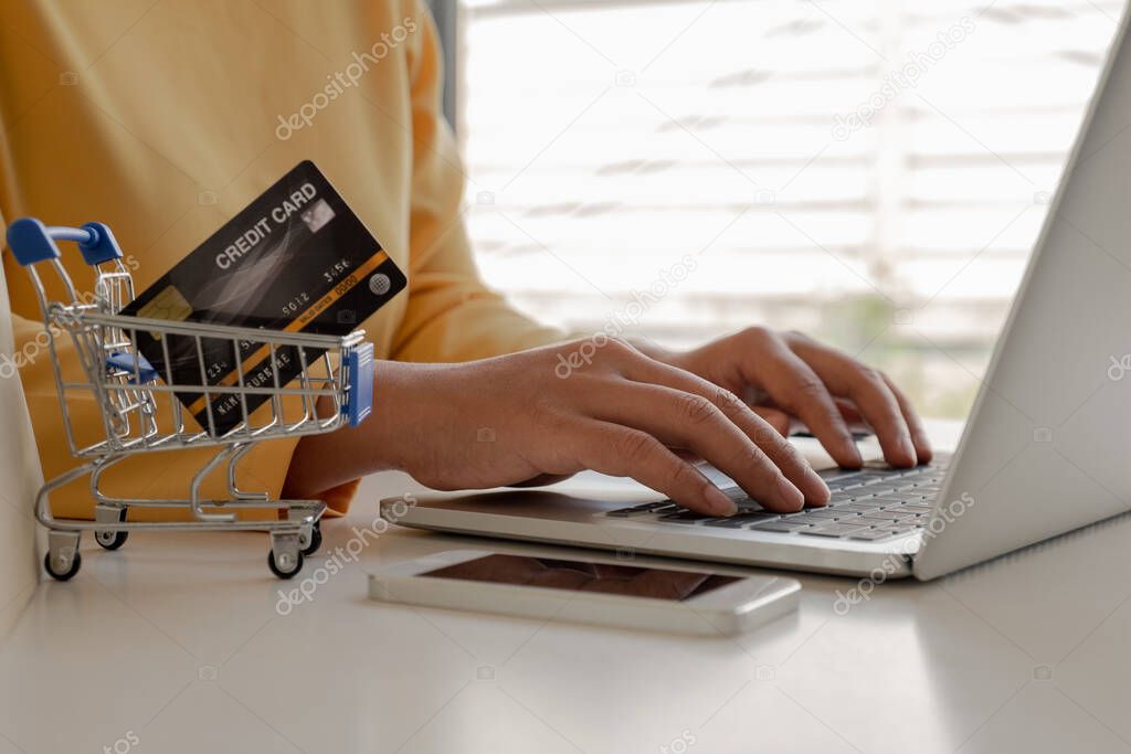 Young lady use credit cards and laptops for online shopping and making payments the internet.