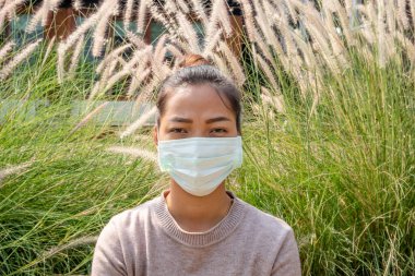 Young woman wearing protection face mask To prevent Virus infection, epidemics covid-19 and PM 2.5. clipart