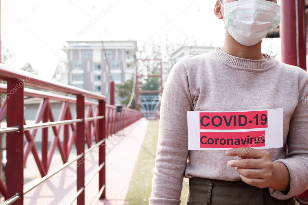 Young woman wearing protection face mask To prevent Virus infection, epidemics covid-19 and PM 2.5.