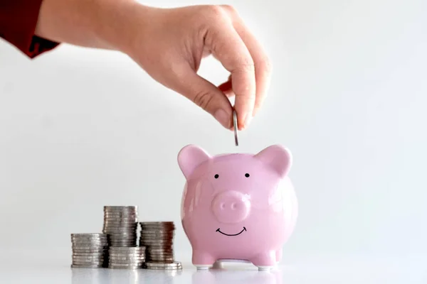 Women are putting coins in the piggy bank Saving money with coins Step into a business that is growing to be successful and save for retirement ideas.