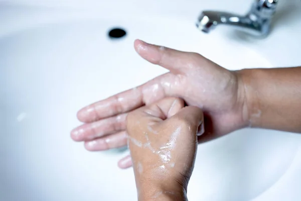 Woman\'s hands wash their hands with soap, cleanse the hands in the tub with soap, personal hygiene.