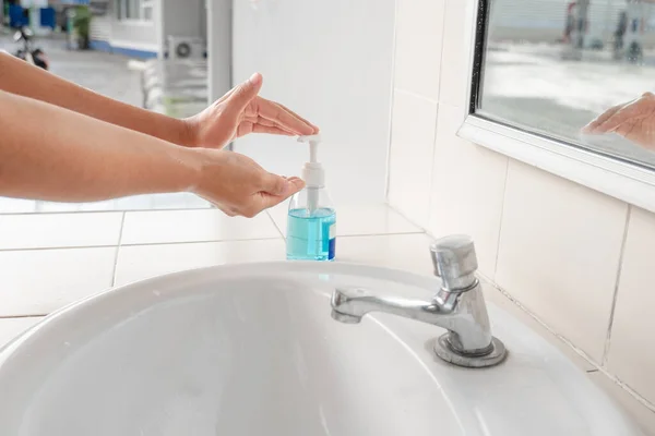 Women wash hands with soap sanitizing hands in the tub with soap, personal hygiene gel.