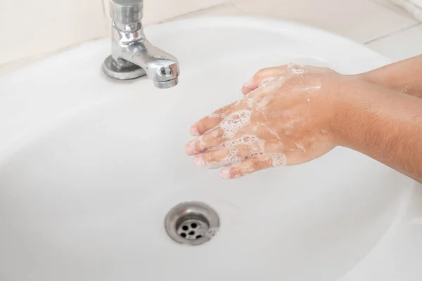Woman\'s hands wash their hands with soap cleanse the hands in the tub with soap, personal hygiene.