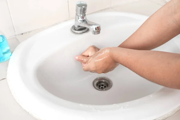 Women wash hands with soap sanitizing hands in the tub with soap, personal hygiene gel.